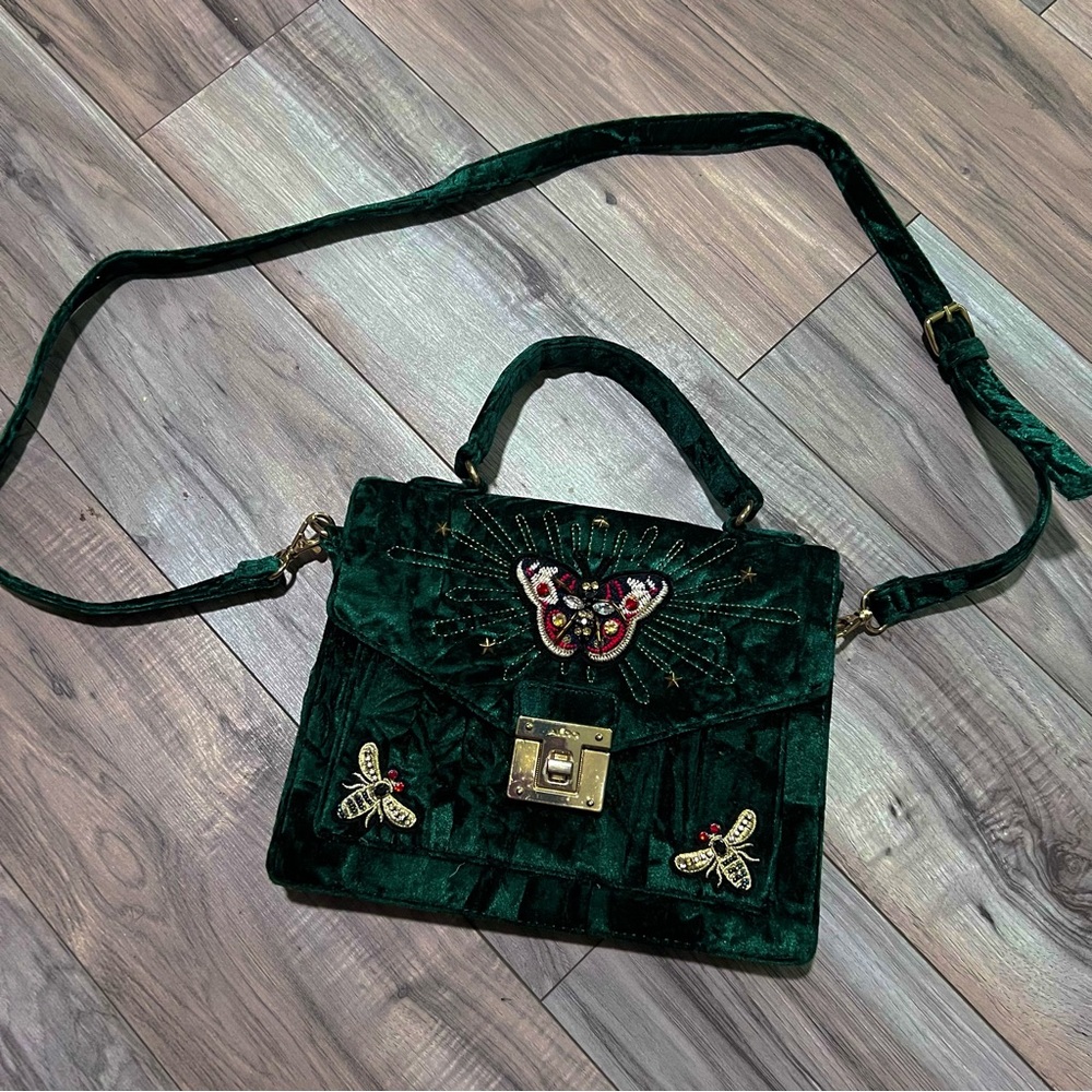 Emerald green velvet ALDO purse.